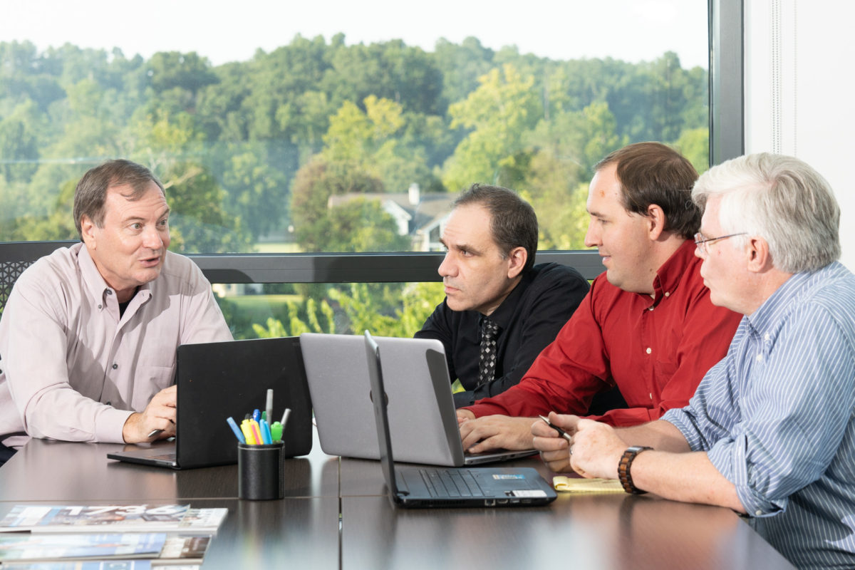 The Cyber Mavens team working together around a conference table